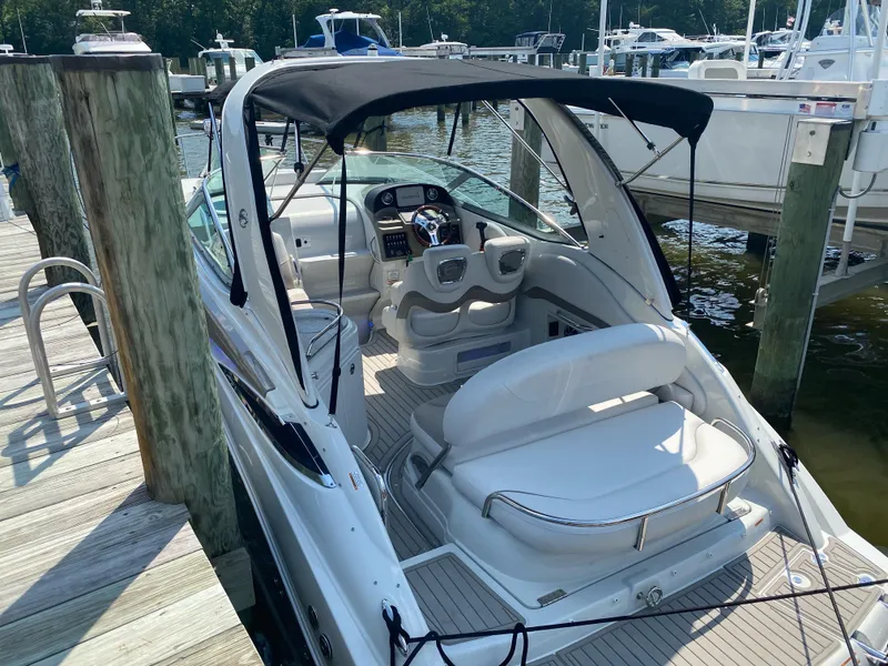 Slide: The Image of 2021 Crownline 264 CR boat docked, featuring sleek design and comfortable seating. - 10