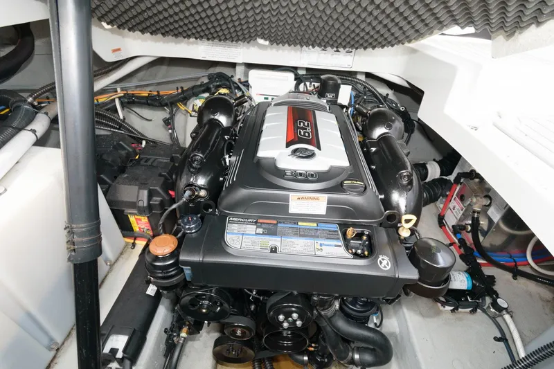 Slide: The Image of Engine compartment of 2021 Crownline 264 CR boat, featuring a powerful inboard motor. - 17