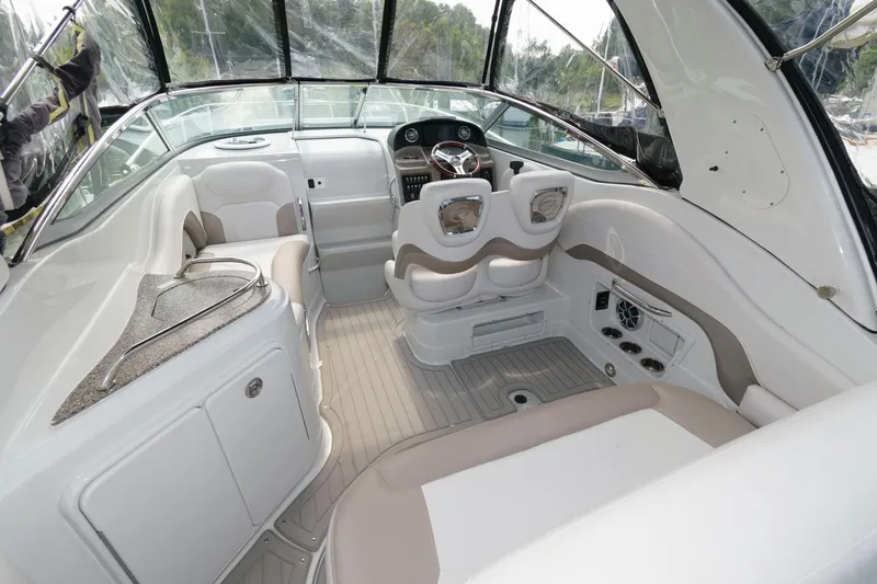Slide: The Image of 2021 Crownline 264 CR boat interior with modern seating and steering area. - 2