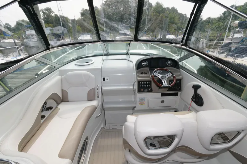 Slide: The Image of 2021 Crownline 264 CR boat interior with modern dashboard and comfortable seating. - 3