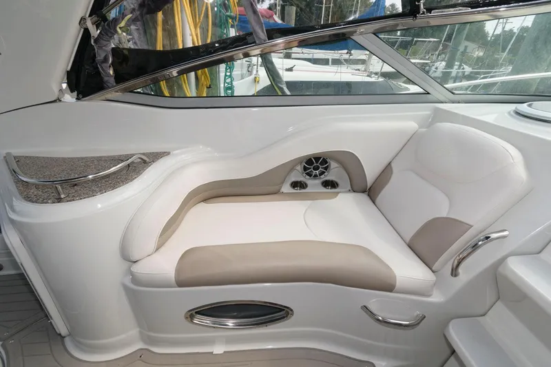 Slide: The Image of 2021 Crownline 264 CR boat interior with cushioned seating and sleek design. - 4