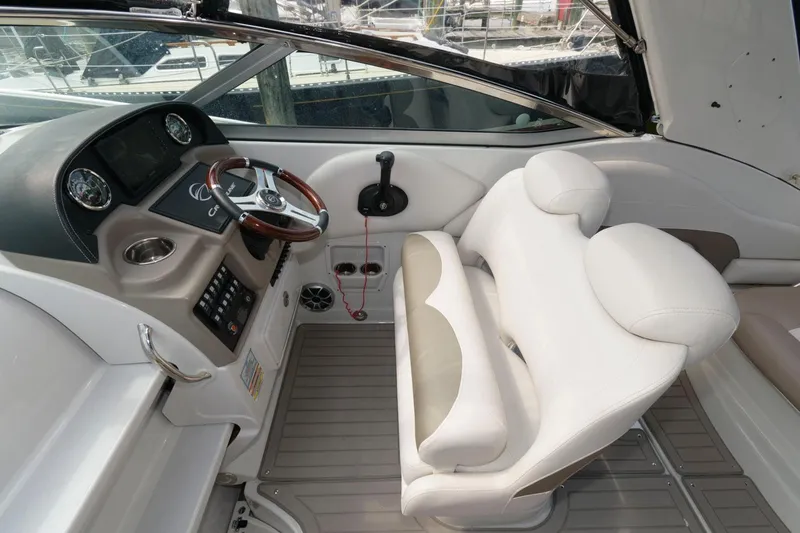 Slide: The Image of 2021 Crownline 264 CR boat cockpit with modern steering and comfortable seating. - 7