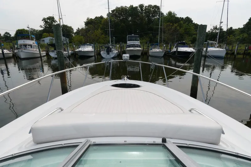 Slide: The Image of 2021 Crownline 264 CR boat docked at a marina with other vessels. - 8