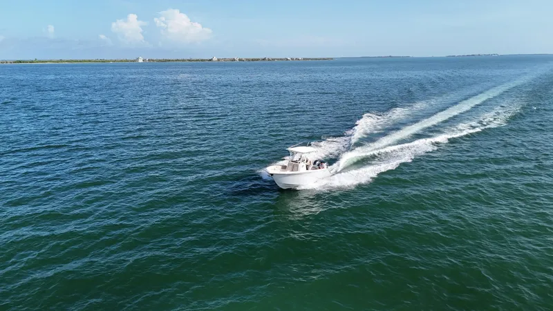 Slide: The Image of A 2017 Sea Fox 266 Commander boat cruising on open water under a clear blue sky. - 12