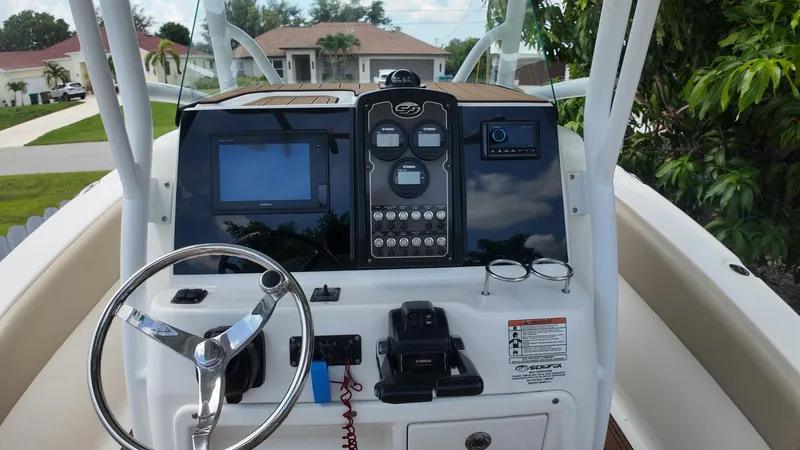 Slide: The Image of 2017 Sea Fox 266 Commander boat dashboard with steering wheel and control panel. - 15