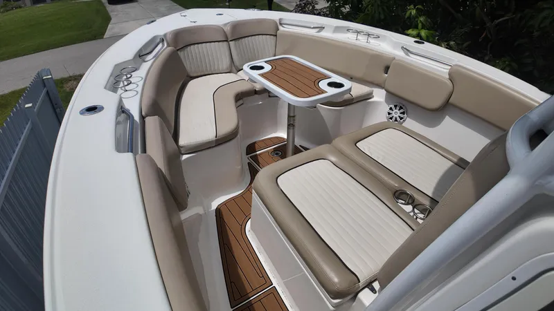 Slide: The Image of 2017 Sea Fox 266 Commander boat interior with cushioned seating and wooden table. - 17