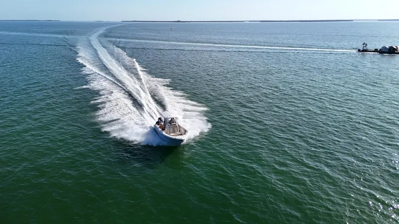Slide: The Image of 2017 Sea Fox 266 Commander speeding across open water, leaving a wake trail. - 2