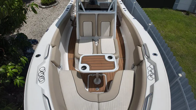 Slide: The Image of 2017 Sea Fox 266 Commander boat interior with cushioned seating and wooden table. - 25