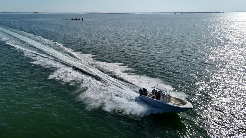 Slide: The Image of 2017 Sea Fox 266 Commander boat speeding on open water, leaving a wake trail. - 29