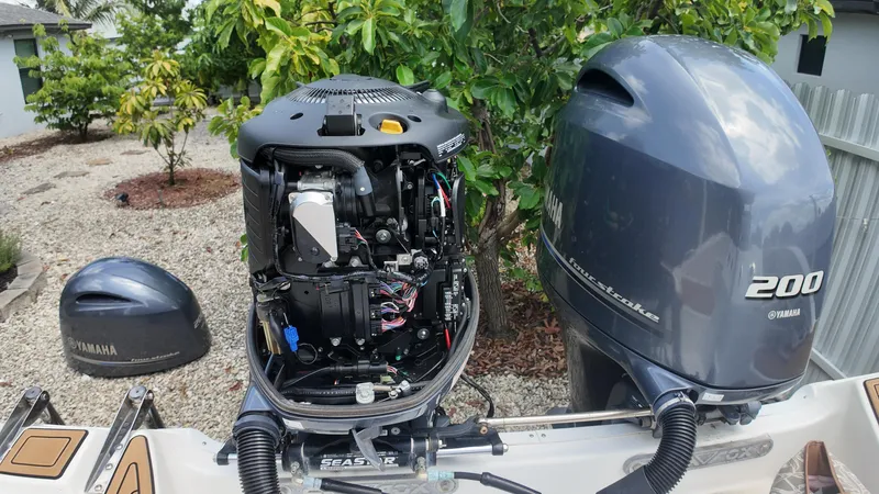 Slide: The Image of Open Yamaha outboard engine on a 2017 Sea Fox 266 Commander boat, with garden background. - 32