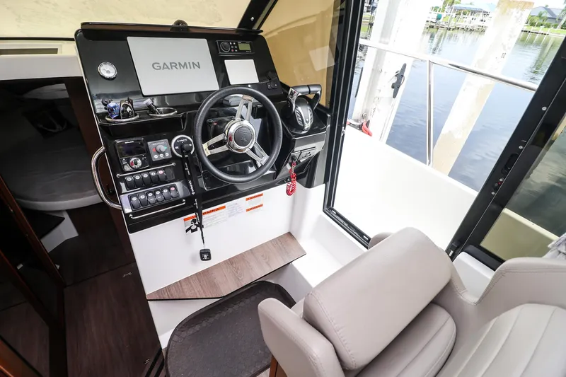 Slide: The Image of 2021 Jeanneau NC 1095 helm with Garmin navigation system and comfortable seating. - 14