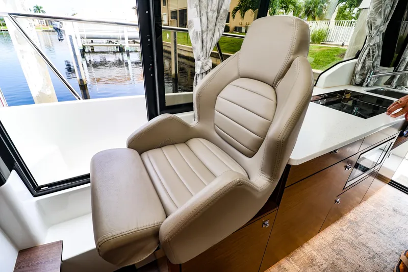 Slide: The Image of Luxurious interior seating on 2021 Jeanneau NC 1095 boat, featuring plush leather chair. - 16