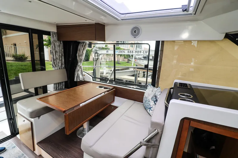 Slide: The Image of Interior of 2021 Jeanneau NC 1095 boat with seating and dining area. - 23