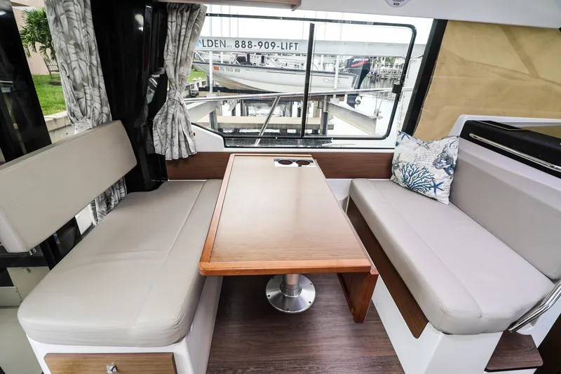 Slide: The Image of Interior of 2021 Jeanneau NC 1095 boat with seating and table. - 25