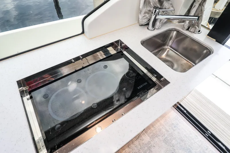 Slide: The Image of Modern kitchen area on 2021 Jeanneau NC 1095 boat with stove and sink. - 27