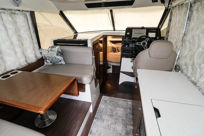 Slide: The Image of Interior of 2021 Jeanneau NC 1095 boat with helm, seating, and dining area. - 28