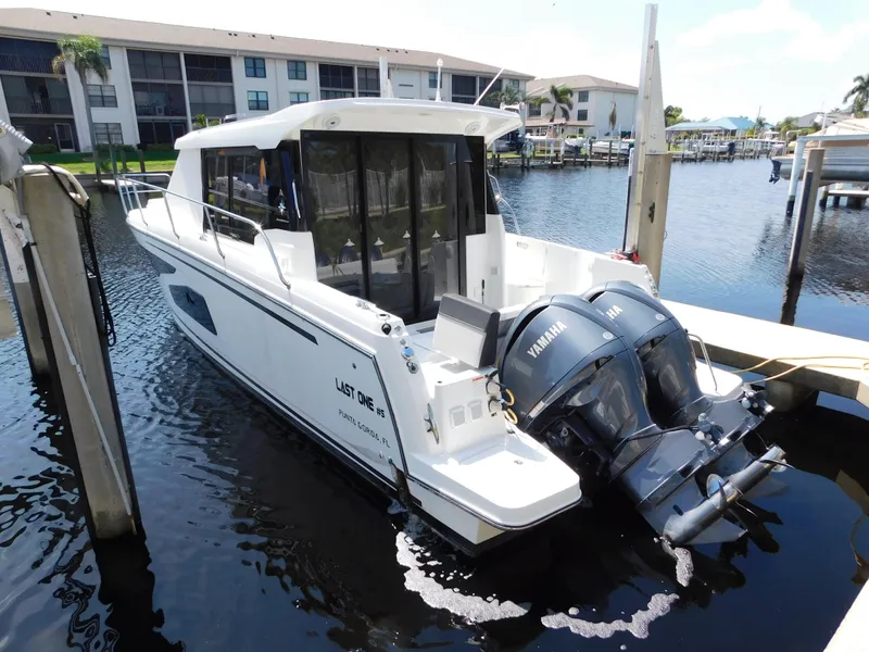 Slide: The Image of 2021 Jeanneau NC 1095 boat docked with twin Yamaha outboard engines. - 3