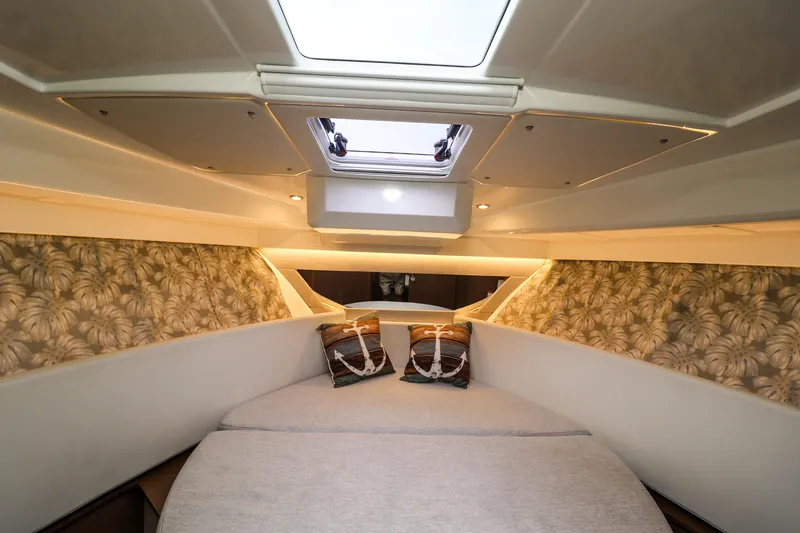Slide: The Image of Interior cabin of 2021 Jeanneau NC 1095 boat with skylight and decorative pillows. - 31