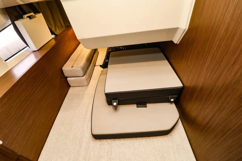 Slide: The Image of 2021 Jeanneau NC 1095 interior cabin with modern wood finish and compact seating. - 36