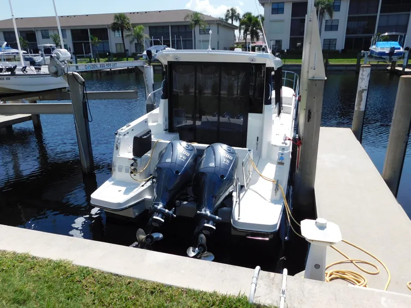 Slide: The Image of 2021 Jeanneau NC 1095 boat docked with dual outboard engines. - 4