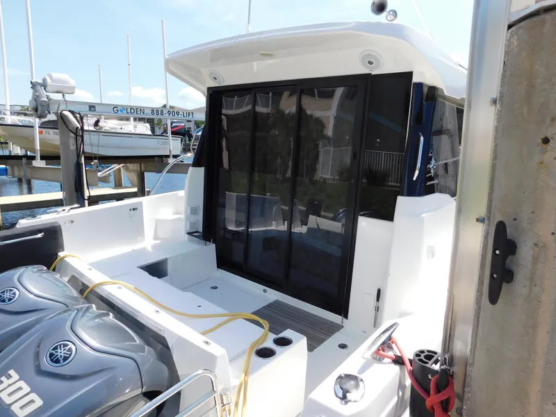 Slide: The Image of 2021 Jeanneau NC 1095 boat with Yamaha engines docked at marina. - 6