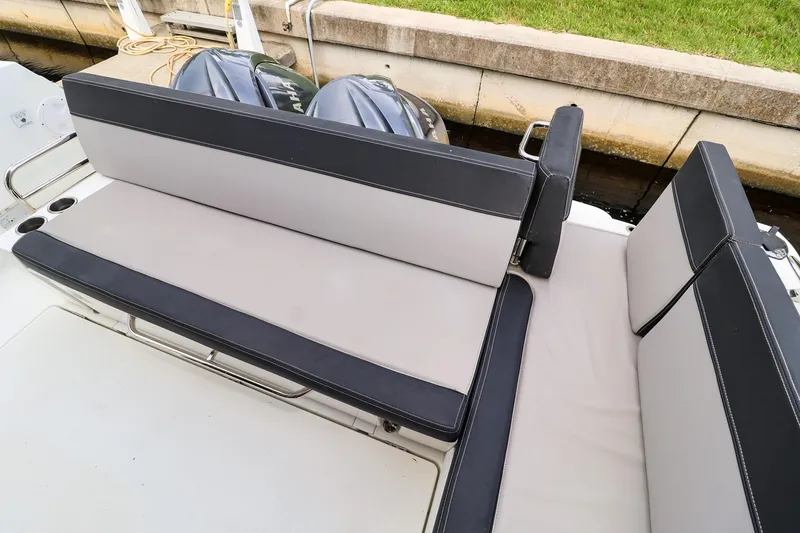 Slide: The Image of 2021 Jeanneau NC 1095 boat seating area with dual outboard motors. - 15