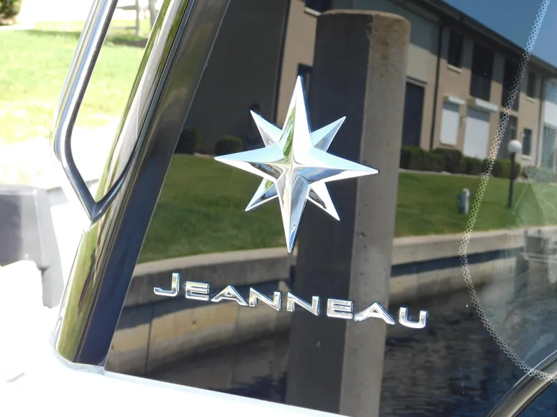 Slide: The Image of Jeanneau NC 1095 2021 logo on boat window, reflecting outdoor scenery. - 41