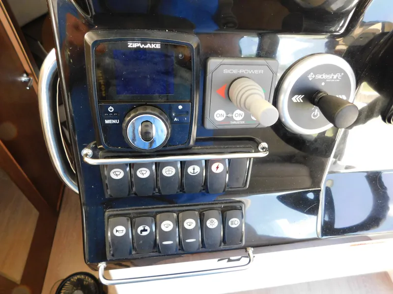 Slide: The Image of Control panel of a 2021 Jeanneau NC 1095 boat with various switches and controls. - 18