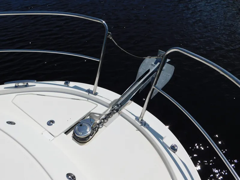 Slide: The Image of Bow of 2021 Jeanneau NC 1095 with anchor and railing over water. - 40