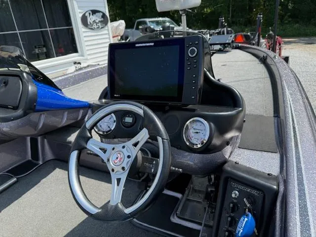 Slide: The Image of 2018 Phoenix 920 ProXP boat dashboard with steering wheel and Humminbird fishfinder. - 4
