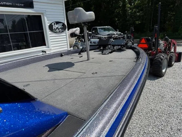 Slide: The Image of 2018 Phoenix 920 ProXP boat with blue accents, parked on gravel near a building. - 5