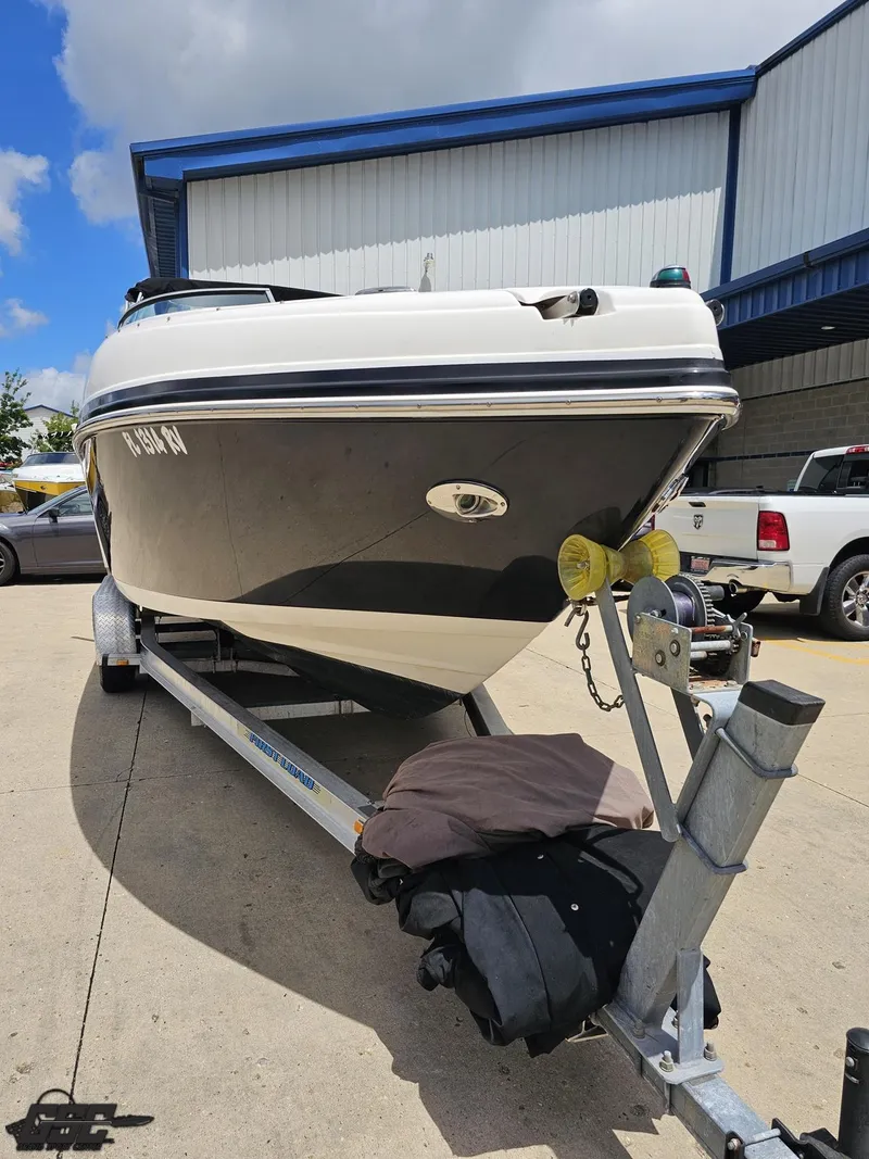 Slide: The Image of 2007 Rinker 246 Captiva Bowrider on trailer, parked outdoors under blue sky. - 10