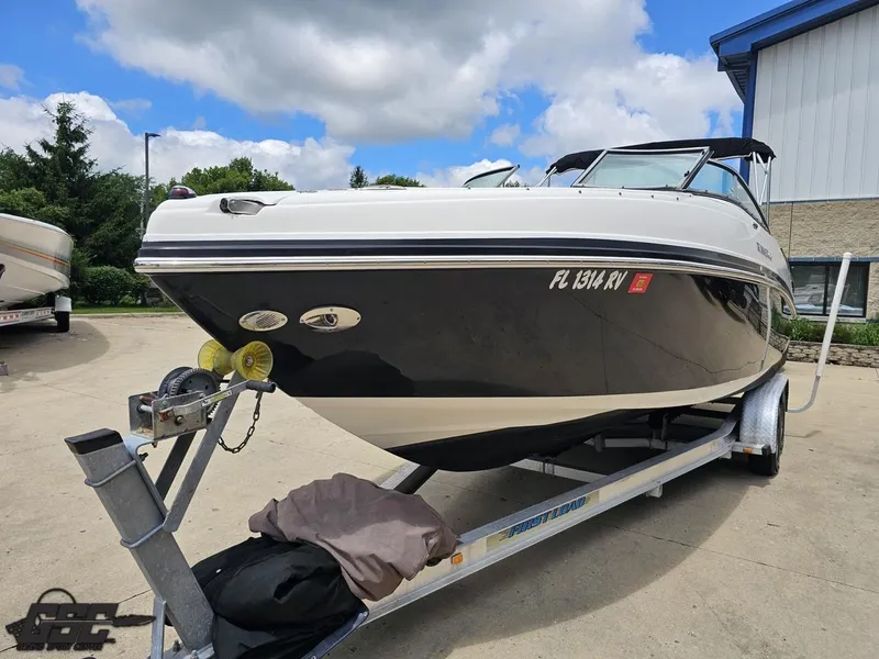 Slide: The Image of 2007 Rinker 246 Captiva Bowrider on trailer, parked outdoors under cloudy sky. - 13