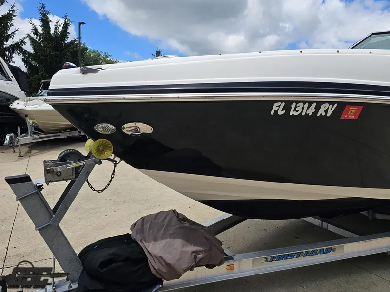 Slide: The Image of 2007 Rinker 246 Captiva Bowrider on trailer, Florida registration visible. - 14