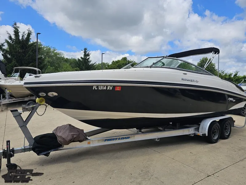 Slide: The Image of 2007 Rinker 246 Captiva Bowrider on trailer, parked outdoors under a cloudy sky. - 15