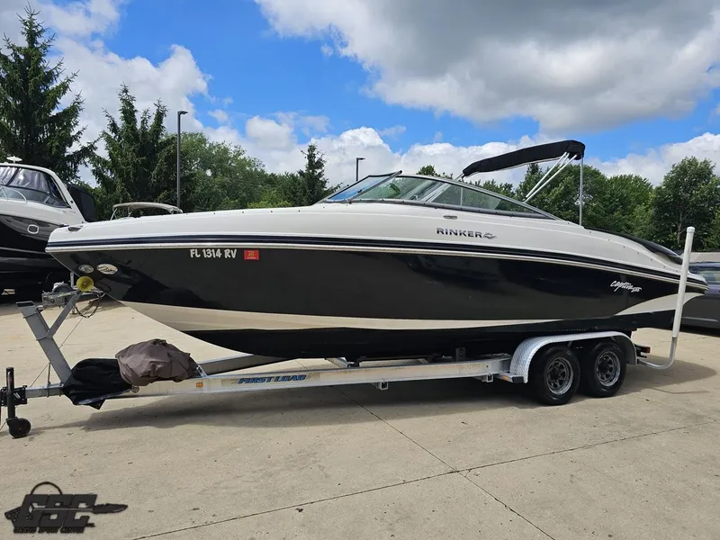 Slide: The Image of 2007 Rinker 246 Captiva Bowrider on trailer, parked outdoors under cloudy sky. - 16