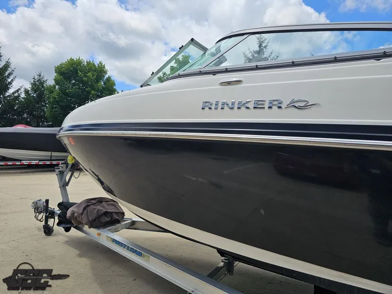 Slide: The Image of 2007 Rinker 246 Captiva Bowrider on trailer, parked outdoors under cloudy sky. - 18
