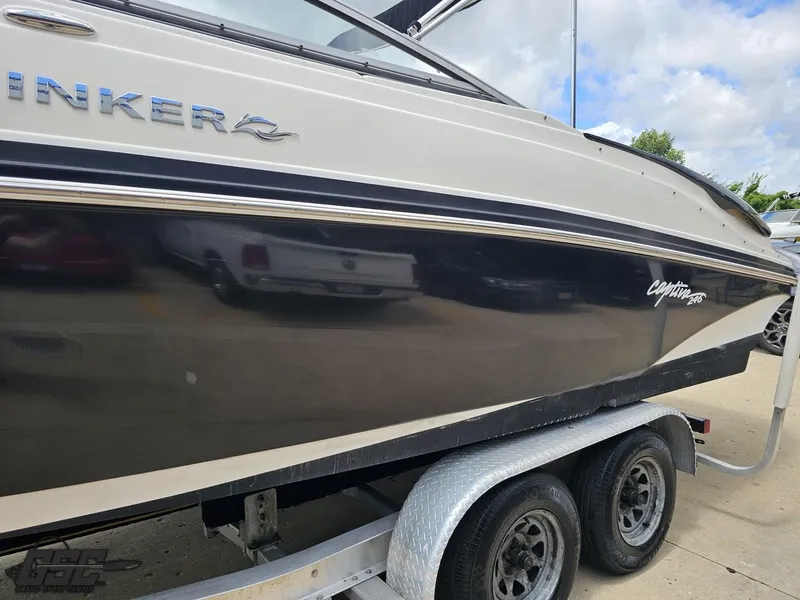 Slide: The Image of 2007 Rinker 246 Captiva Bowrider on trailer, side view, black and white exterior. - 19