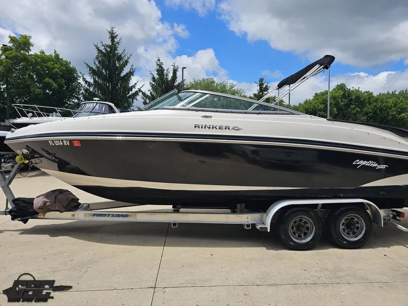 Slide: The Image of 2007 Rinker 246 Captiva Bowrider on trailer, parked outdoors under cloudy sky. - 21