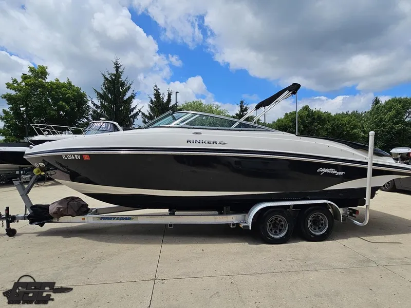 Slide: The Image of 2007 Rinker 246 Captiva Bowrider on trailer, parked outdoors under cloudy sky. - 22