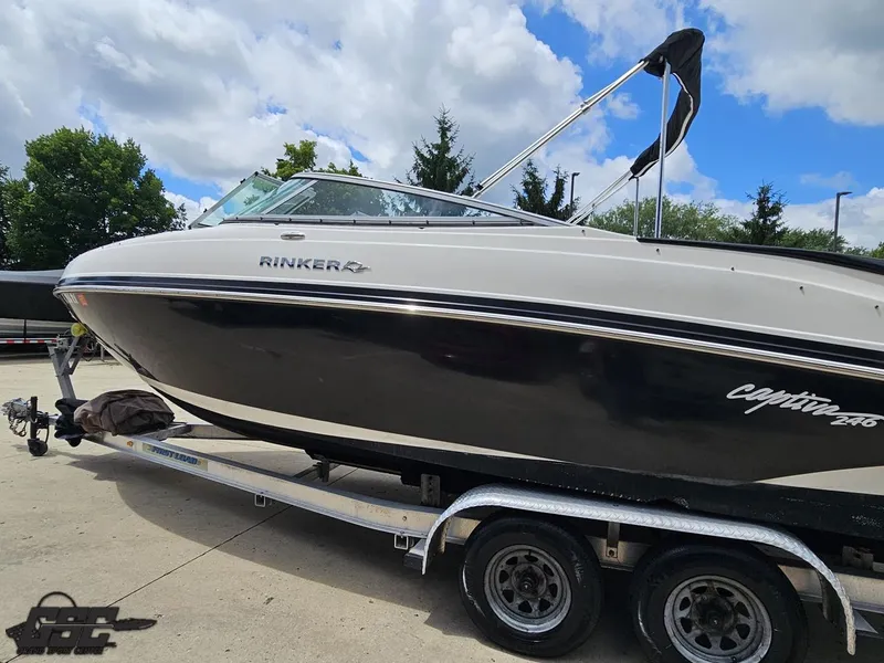 Slide: The Image of 2007 Rinker 246 Captiva Bowrider on trailer, parked outdoors under cloudy sky. - 23