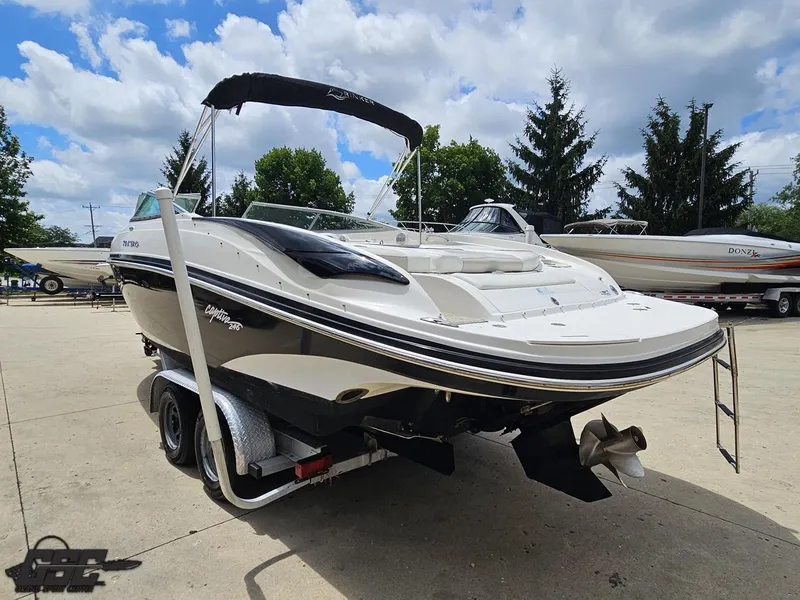 Slide: The Image of 2007 Rinker 246 Captiva Bowrider on trailer, parked outdoors under cloudy sky. - 25