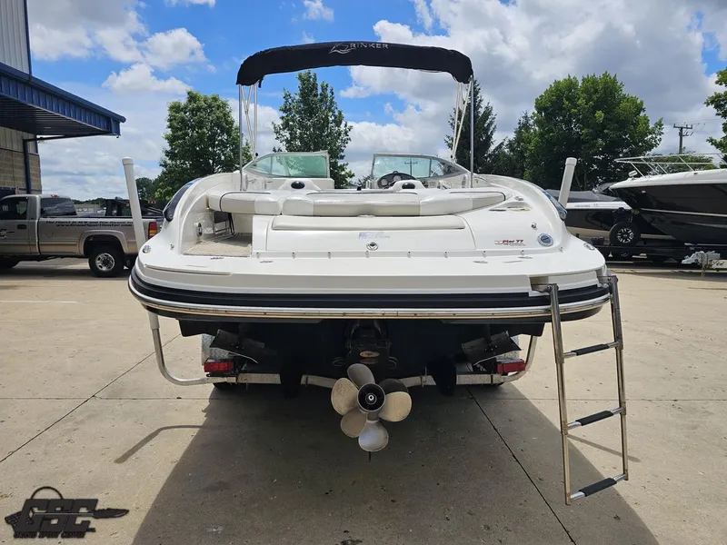 Slide: The Image of 2007 Rinker 246 Captiva Bowrider boat with ladder, parked outdoors on a sunny day. - 26