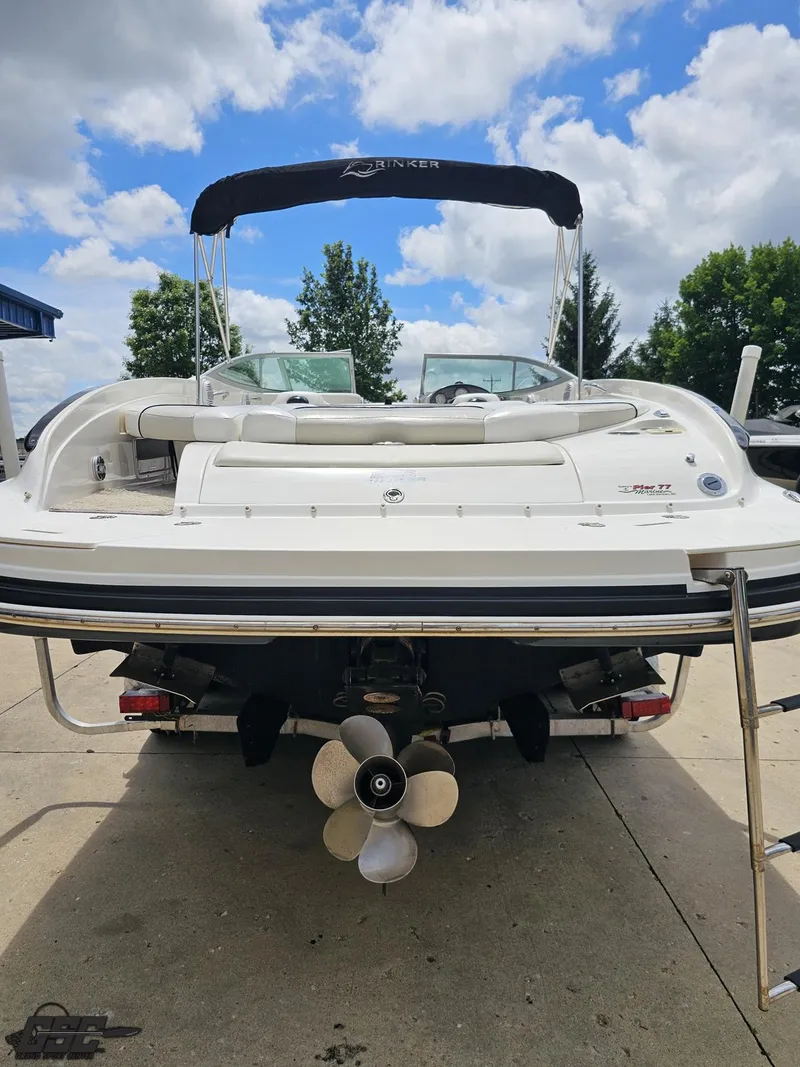 Slide: The Image of 2007 Rinker 246 Captiva Bowrider boat, rear view, with propeller and canopy, outdoors. - 27