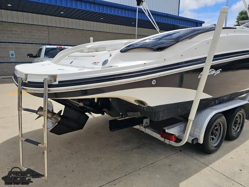Slide: The Image of 2007 Rinker 246 Captiva Bowrider on trailer, rear view with ladder and propeller. - 29