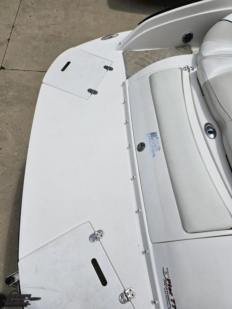 Slide: The Image of 2007 Rinker 246 Captiva Bowrider boat deck with white seating and storage compartments. - 31