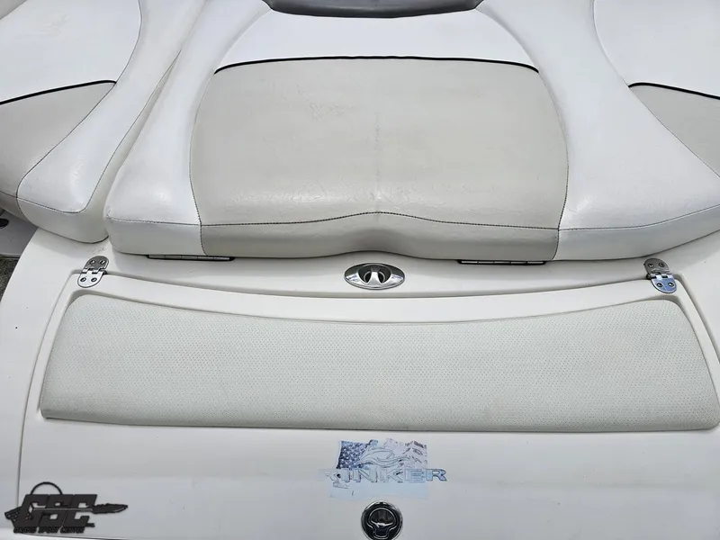 Slide: The Image of 2007 Rinker 246 Captiva Bowrider boat seat with white and gray upholstery. - 33