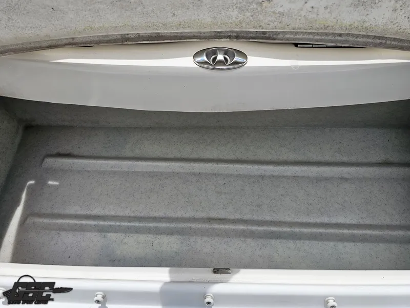 Slide: The Image of 2007 Rinker 246 Captiva Bowrider storage compartment, featuring a clean, spacious interior. - 34