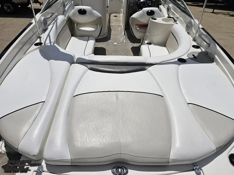 Slide: The Image of 2007 Rinker 246 Captiva Bowrider interior with white and gray seating, cup holders, and dashboard. - 35