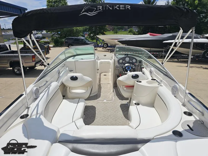 Slide: The Image of 2007 Rinker 246 Captiva Bowrider with white interior and canopy, parked outdoors. - 37